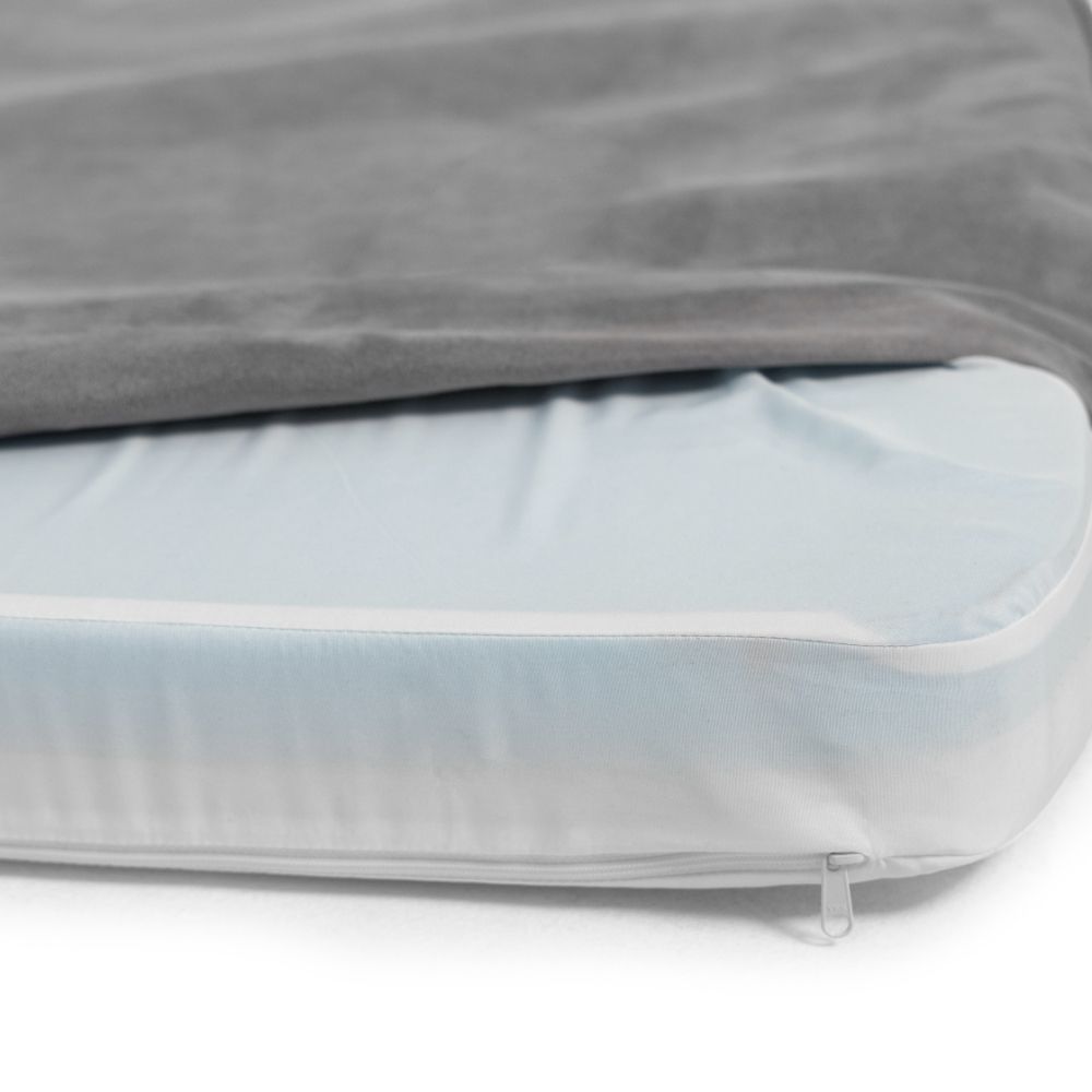 a close up of a Snooz with the outer cover unzipped, exposing the inner liner