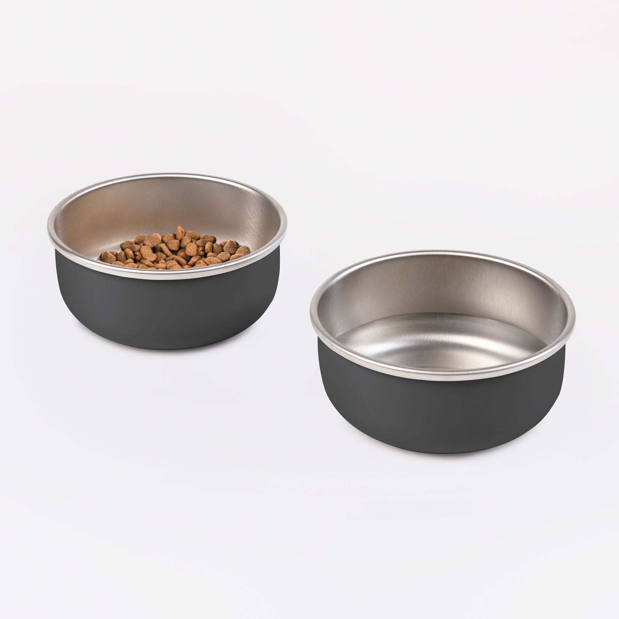 Two charcoal of DIGGS Bowls. One has water in it while the other has dog food.