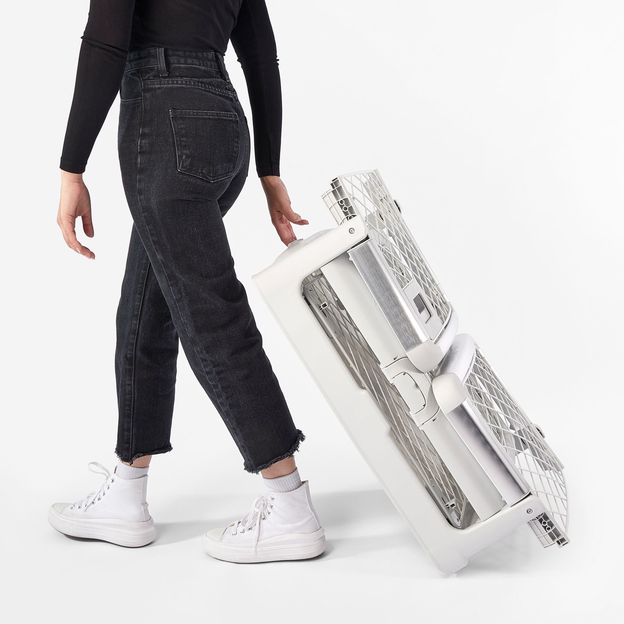 a woman is wheeling a collapsed Ash Revol crate