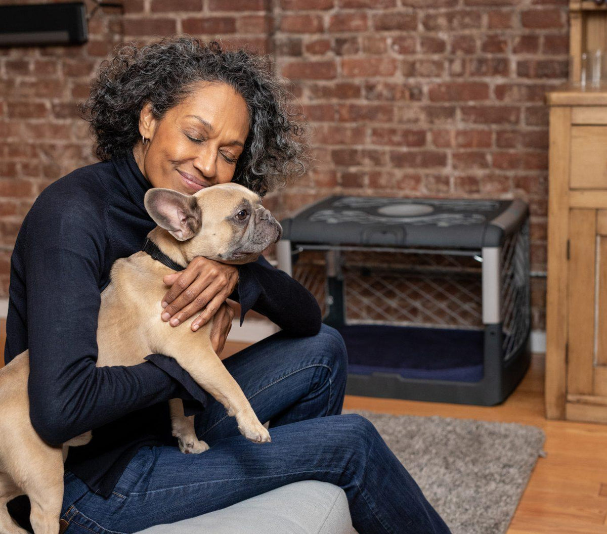 The owner hugging her dog while sitting in a couch next to an open garage door Revol.