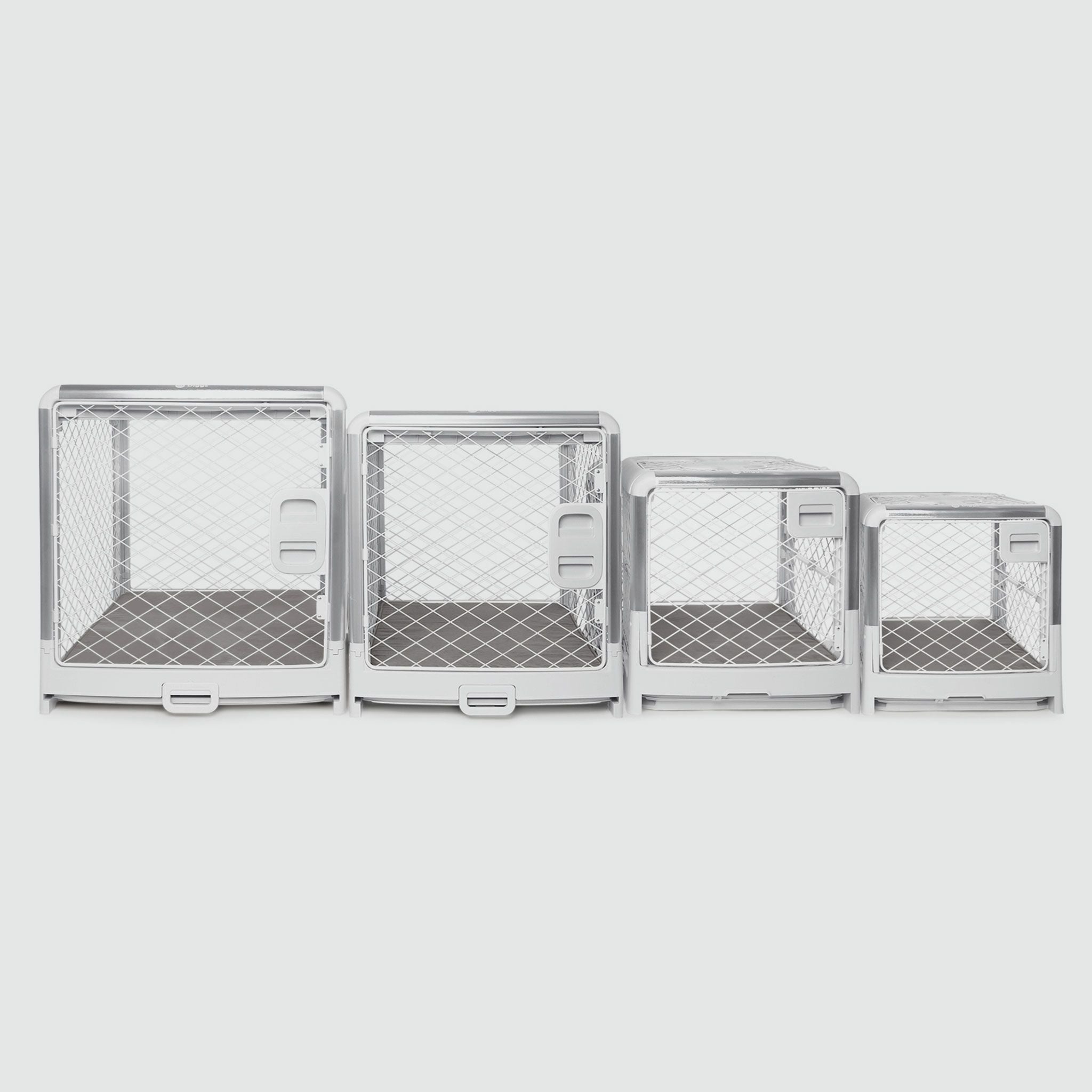 A set of four metal dog crates with doors