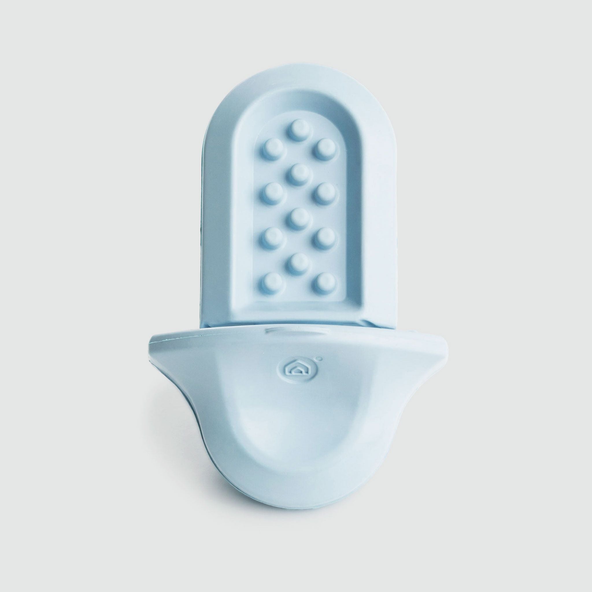 A light blue (ice) Groov training aid on a light grey background