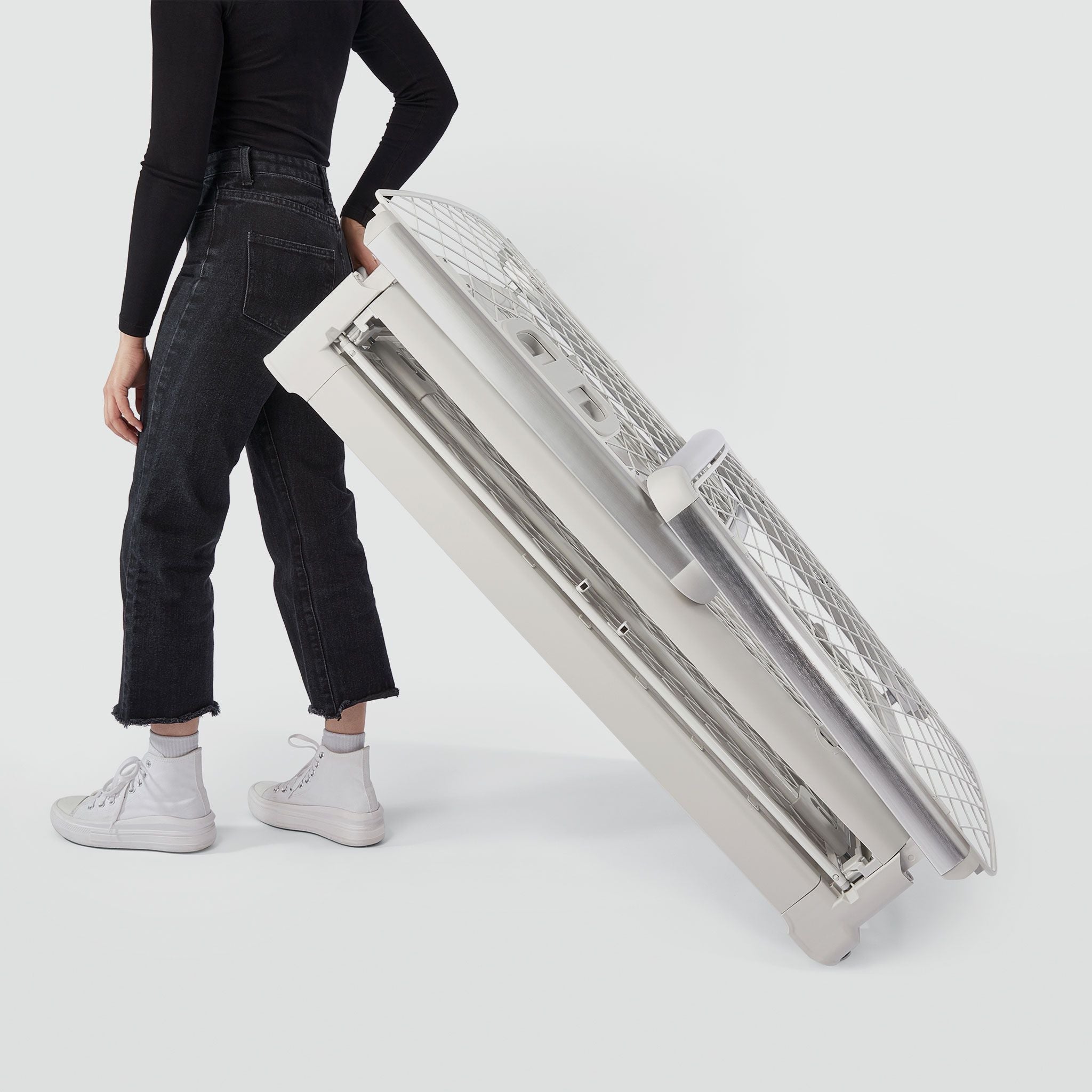 A woman wheeling a folded Revol crate