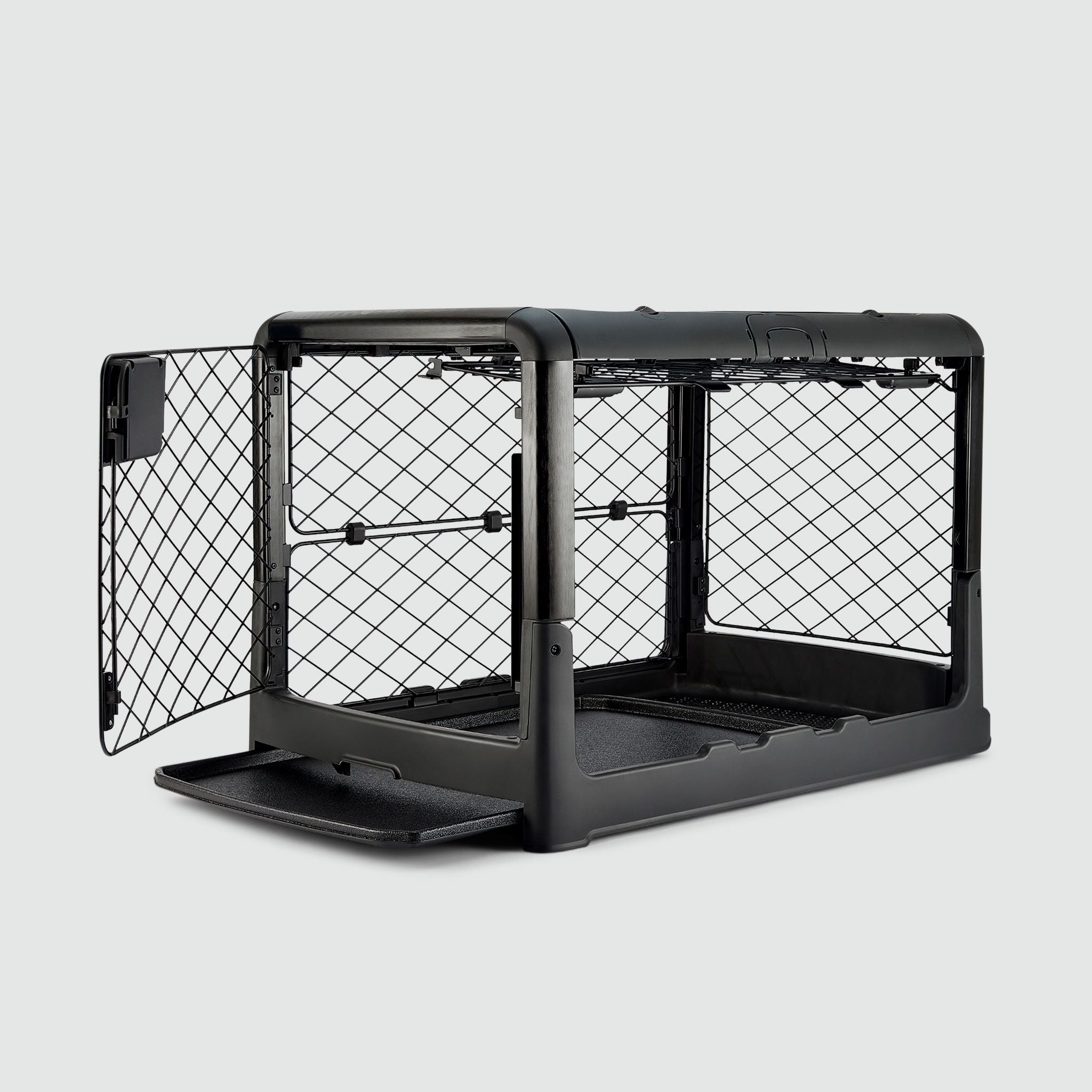 A black dog crate with open doors