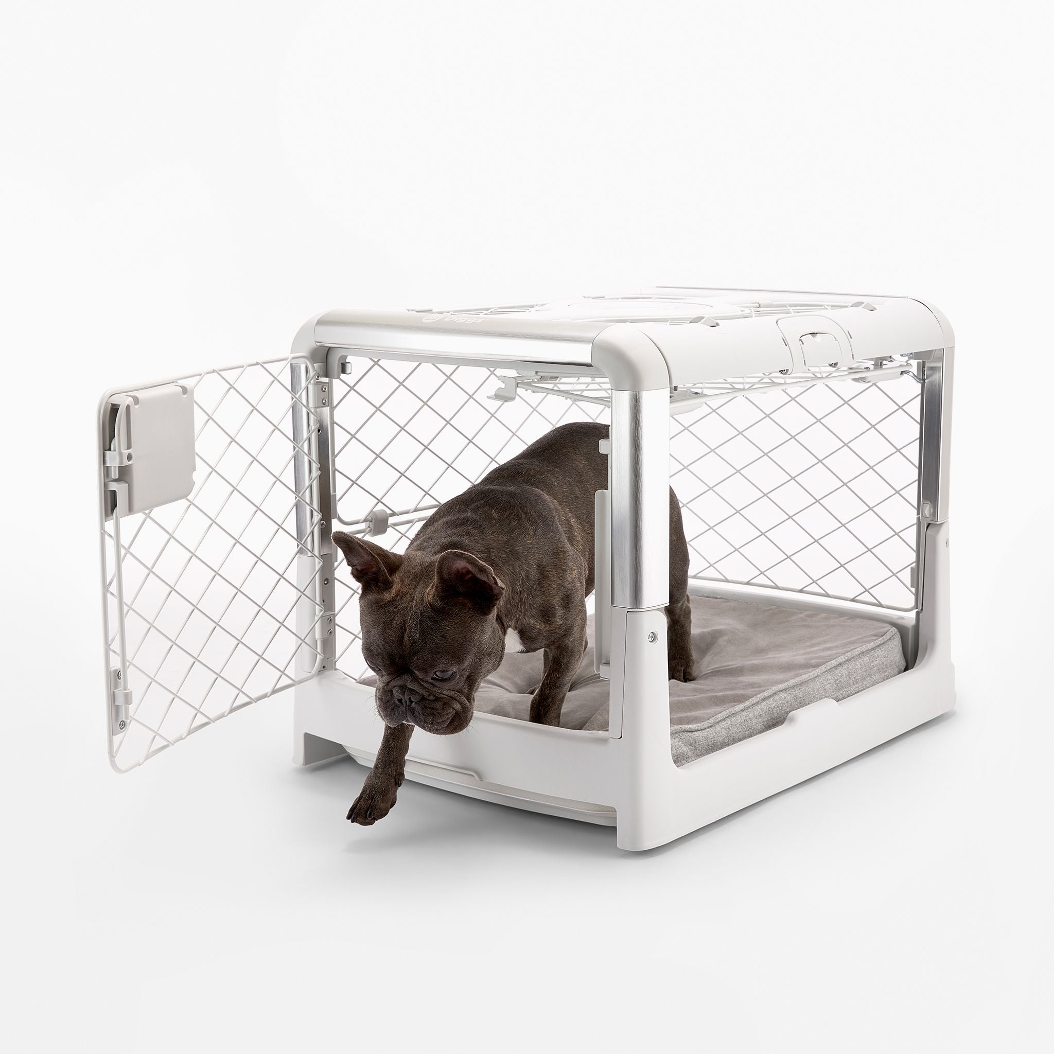 a dog stepping out of a Revol crate with the front and side doors open