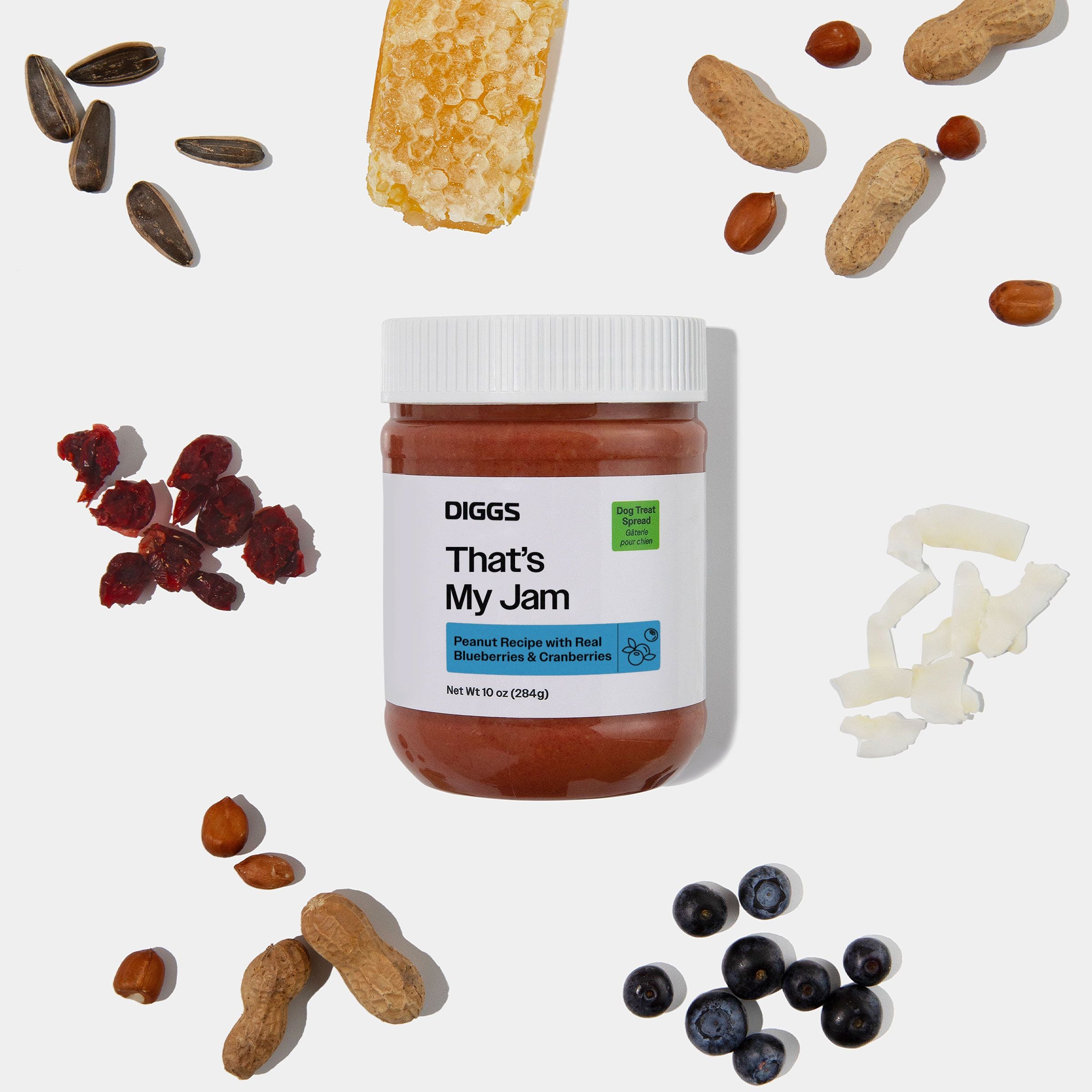 That's My Jam Peanut Butter Treat Spread on white background beside its ingredients (blueberry, cranberry, peanut, etc.)
